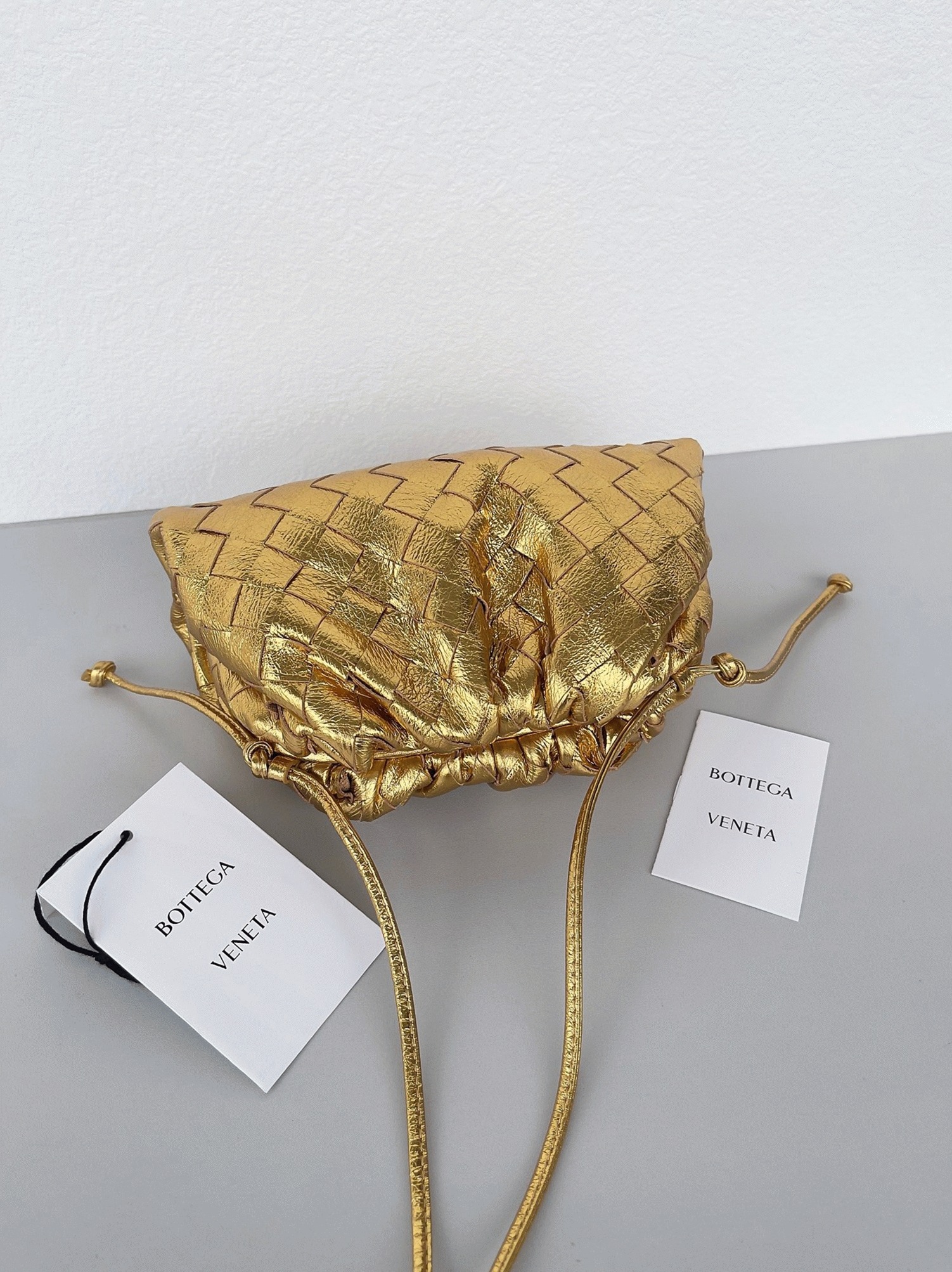 Knockoff B0tt*ga Ven*ta Mini Pouch with Strap Gold