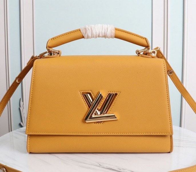 L0vis Vvtt0n Twist One Handle MM Handbag In Vibrant Honey