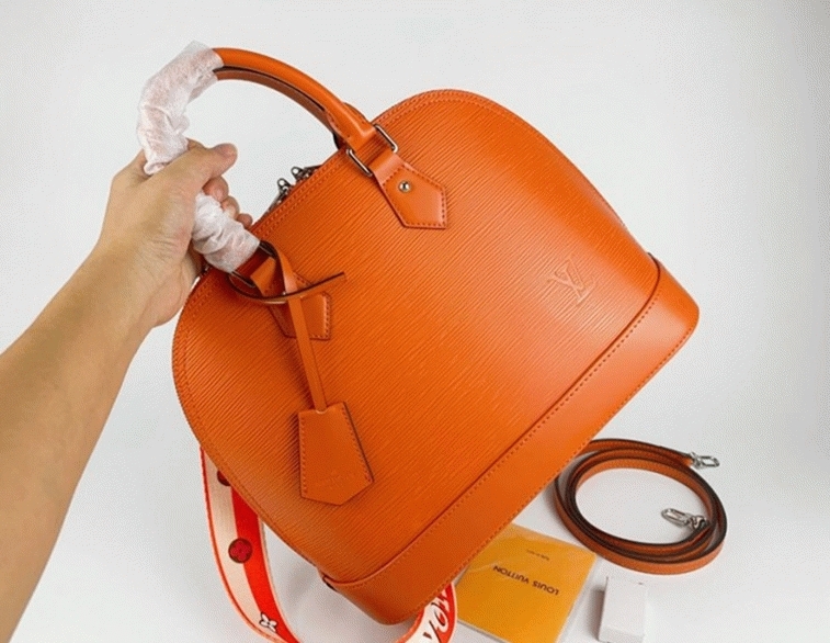 L0vis Vvtt0n Epi Leather Alma PM Handbag In Orange With Jacquard Strap
