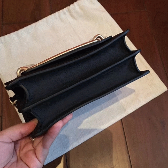 Black knockoff H**me5 Mini Sac Roulis handbag