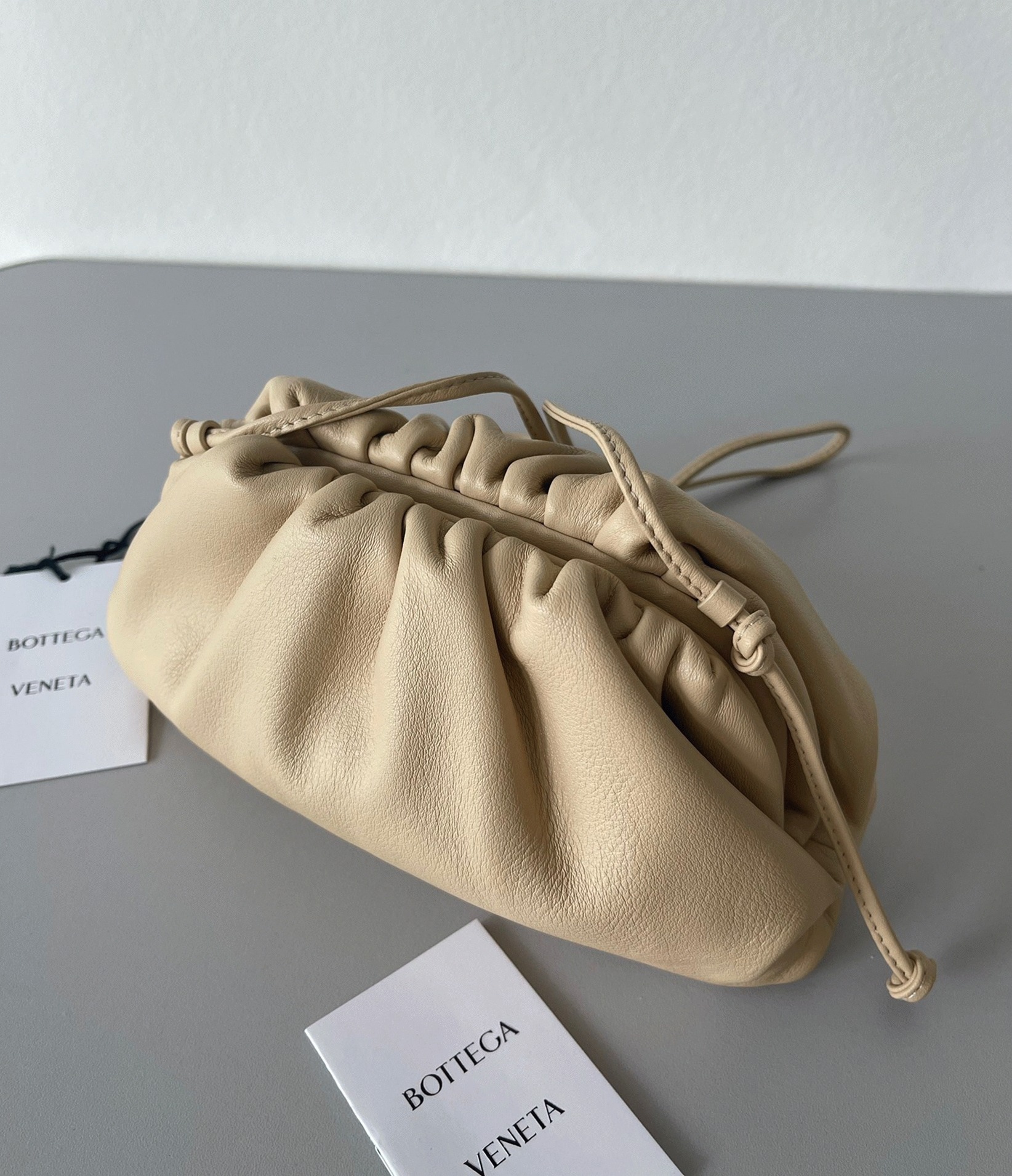 Fake B0tt*ga Ven*ta Mini Pouch with Strap Almond