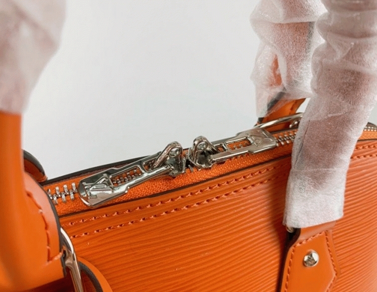 L0vis Vvtt0n Epi Leather Alma PM Handbag In Orange With Jacquard Strap