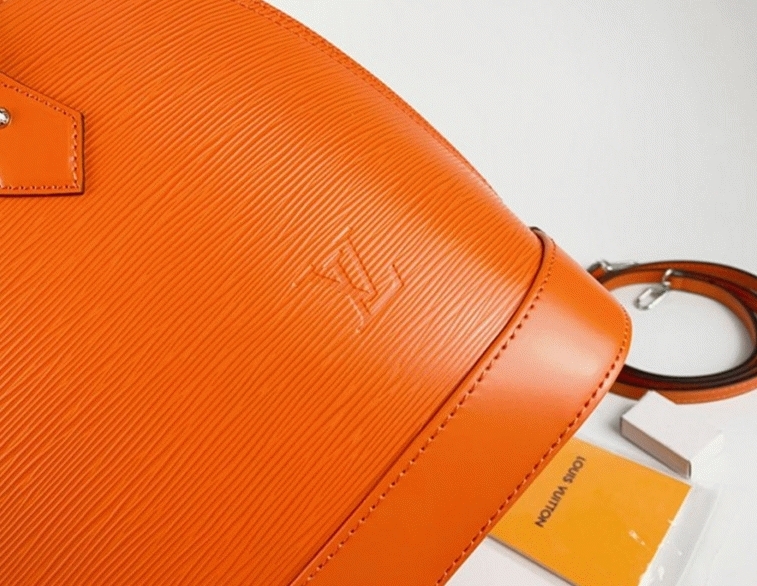 L0vis Vvtt0n Epi Leather Alma PM Handbag In Orange With Jacquard Strap