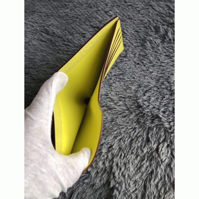 Yellow knockoff H**me5 Copernic compact wallet
